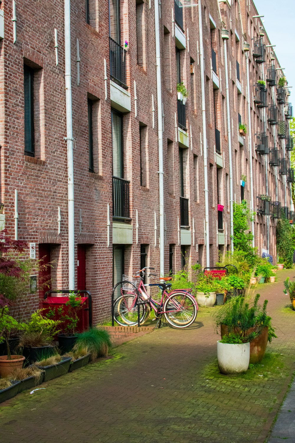 a bike parked in front of a tall brick building