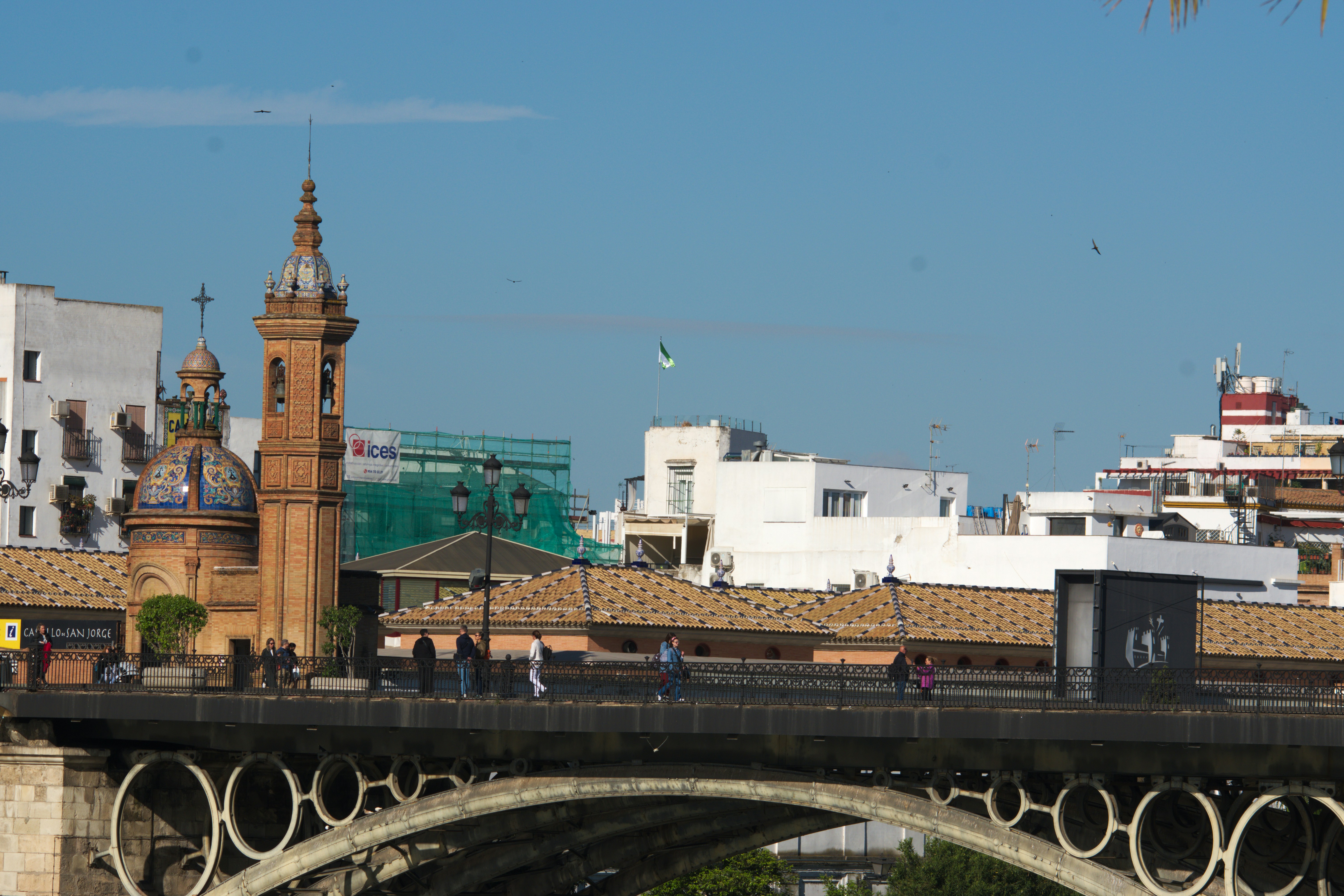 a bridge with a clock tower in the background