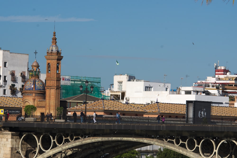 a bridge with a clock tower in the background