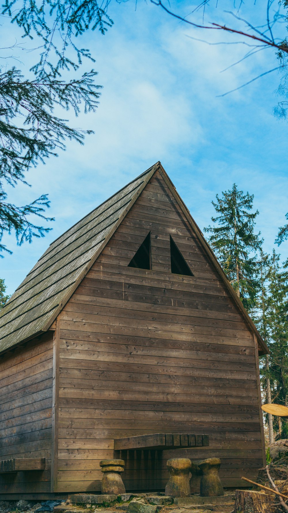 a wooden building with a wooden bench in front of it