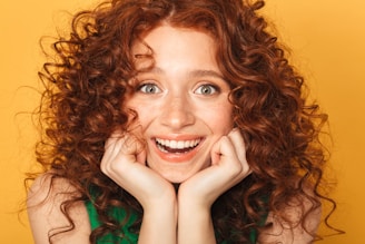 a woman with curly hair and a green shirt