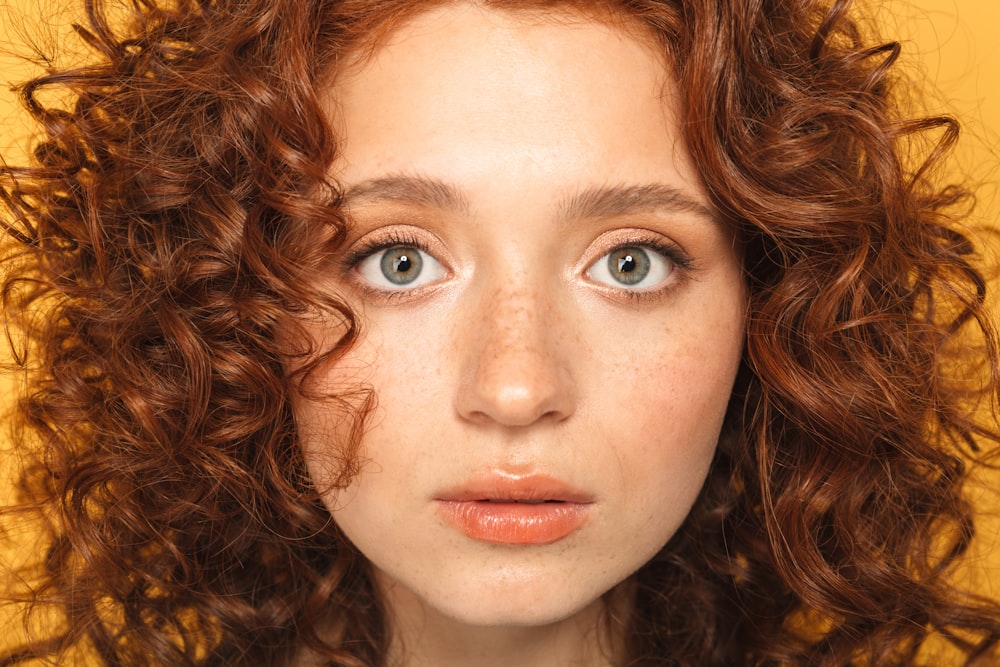 a close up of a person with curly hair