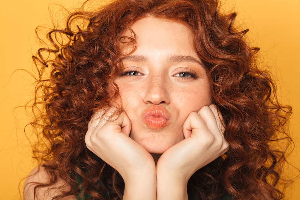 a woman making a funny face with her hands