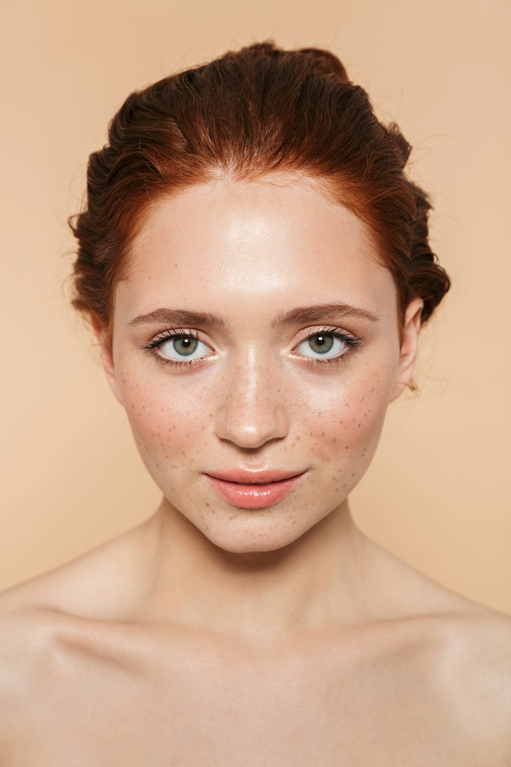 a woman with freckled hair and blue eyes