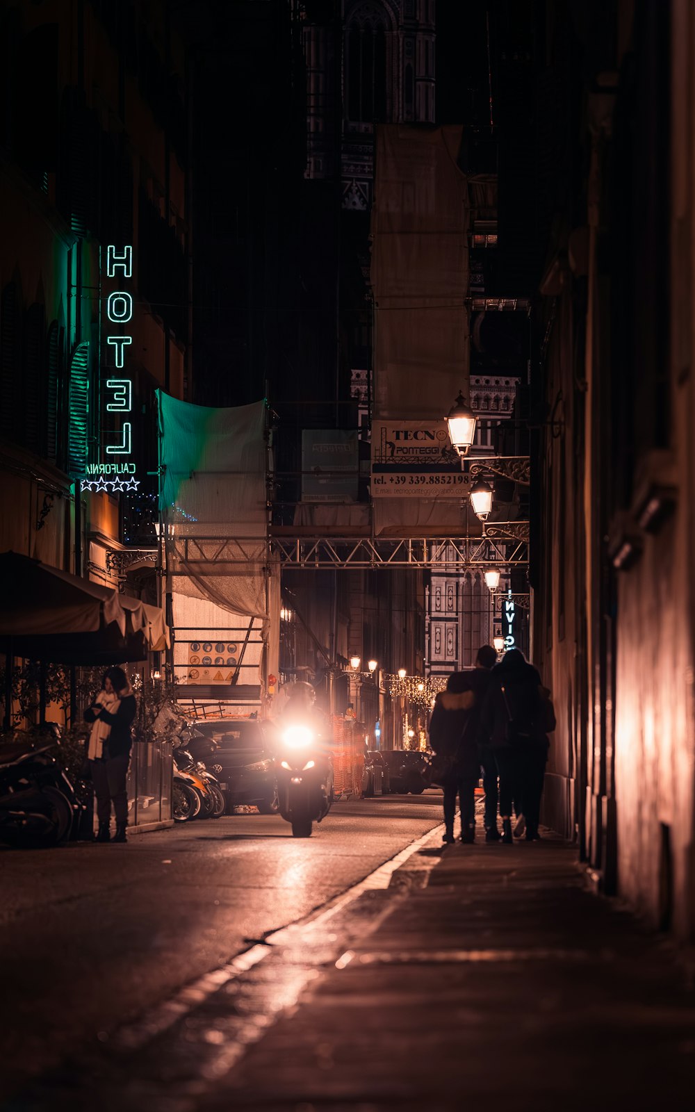 a car driving down a street at night