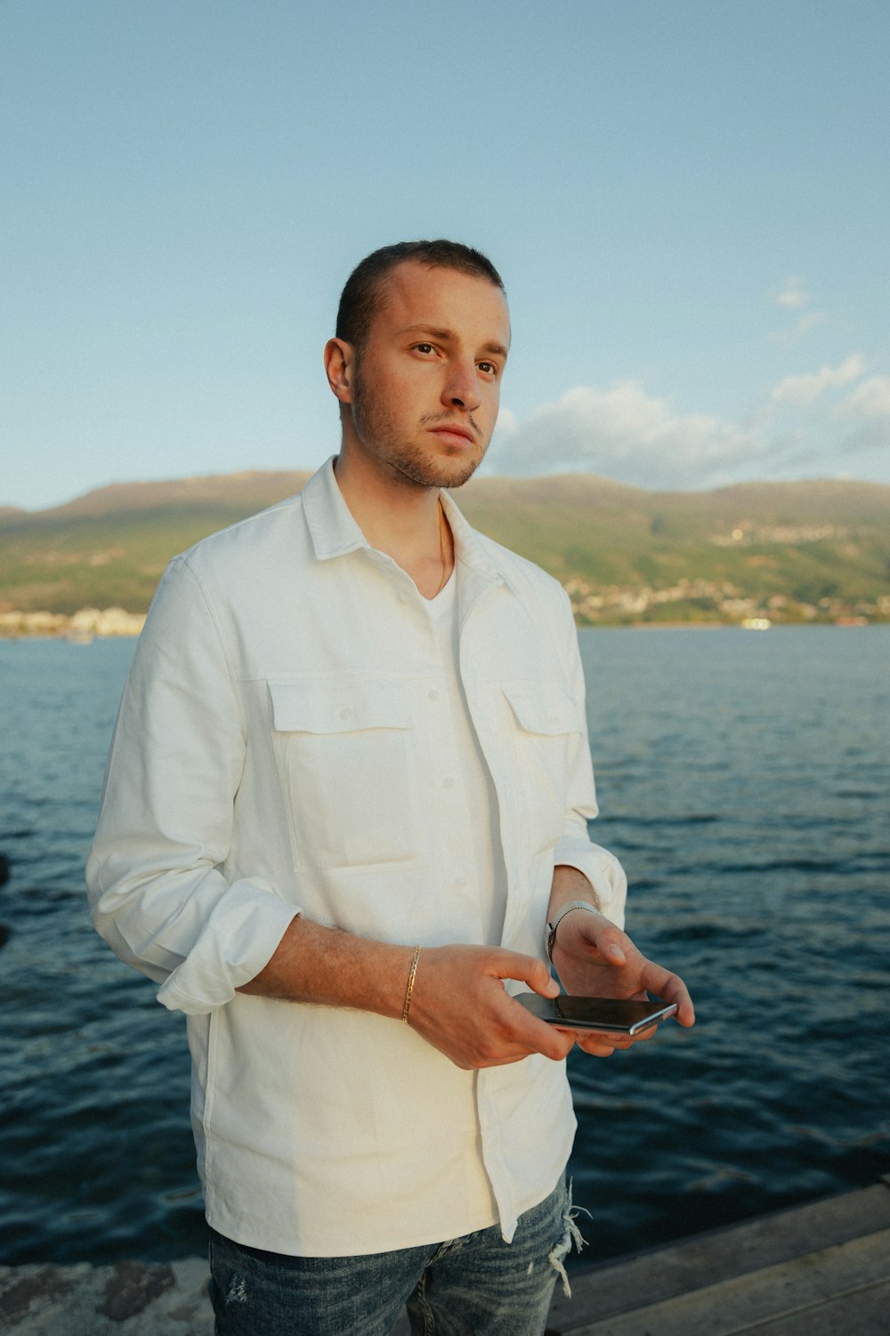 a man standing on a dock holding a plate of food