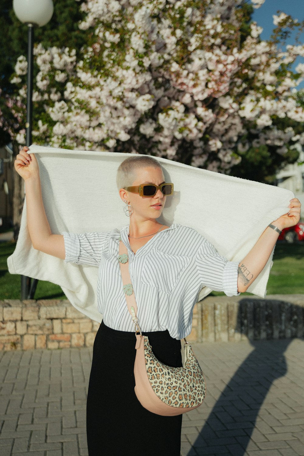 a woman holding a white cloth over her head