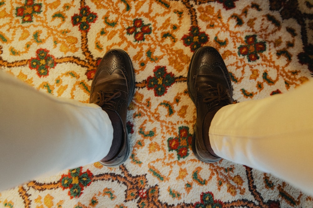 a person standing on top of a rug on a floor