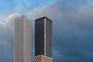 a couple of tall buildings sitting next to each other