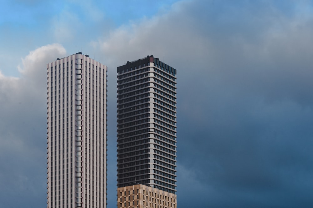 a couple of tall buildings sitting next to each other