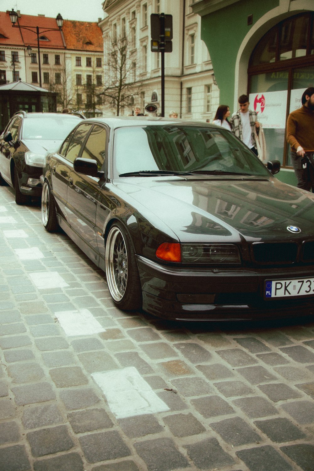 a black car parked on the side of a street