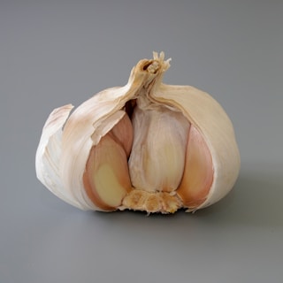 a close up of a garlic on a gray background