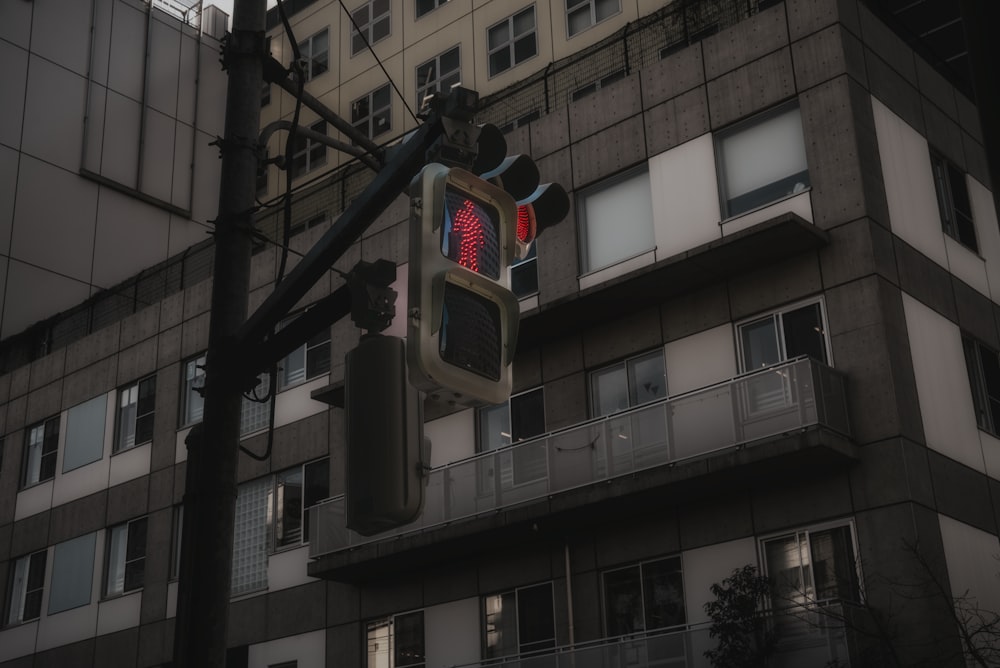 a traffic light on a pole in front of a building