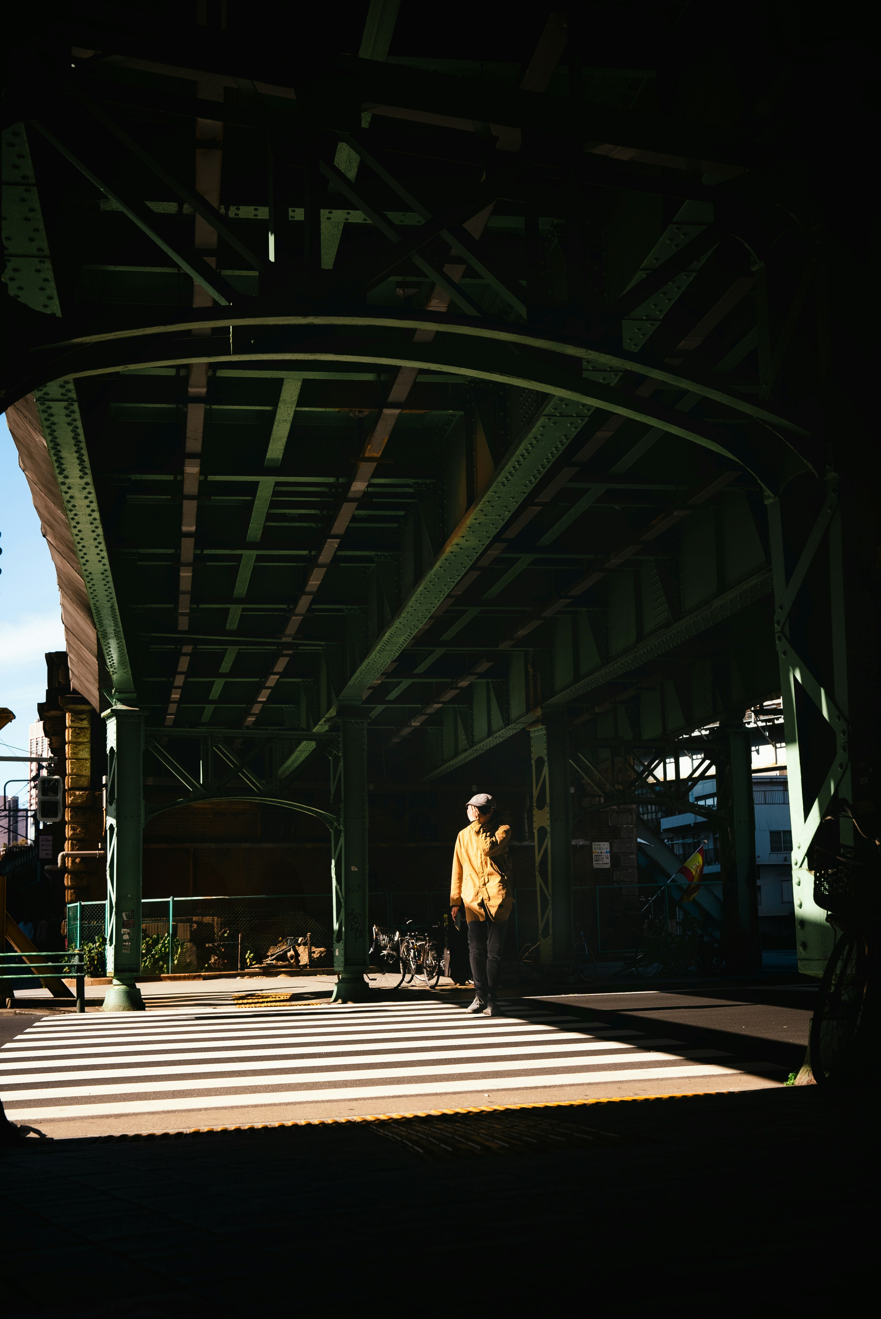 a person standing under a large metal structure