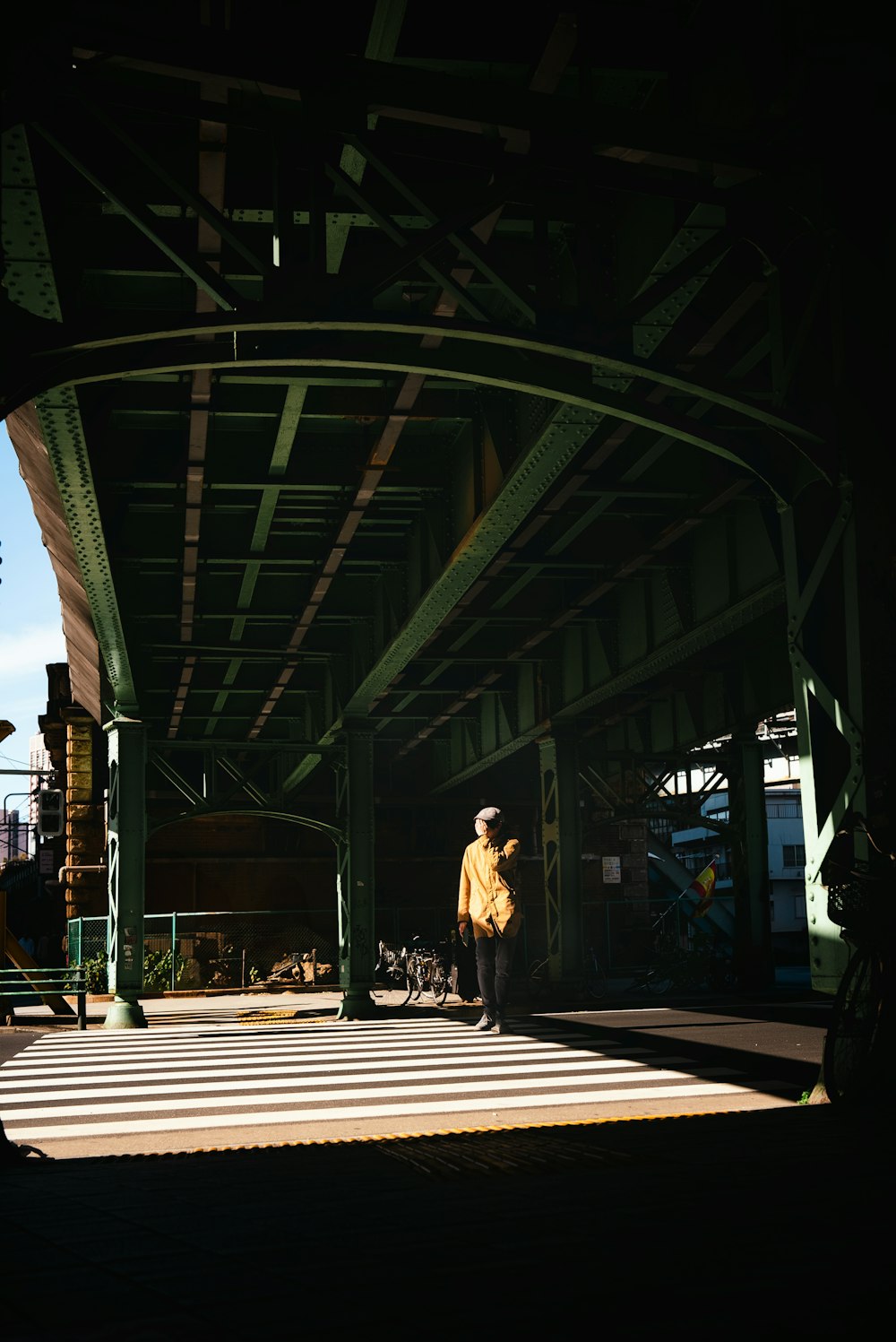 a person standing under a large metal structure