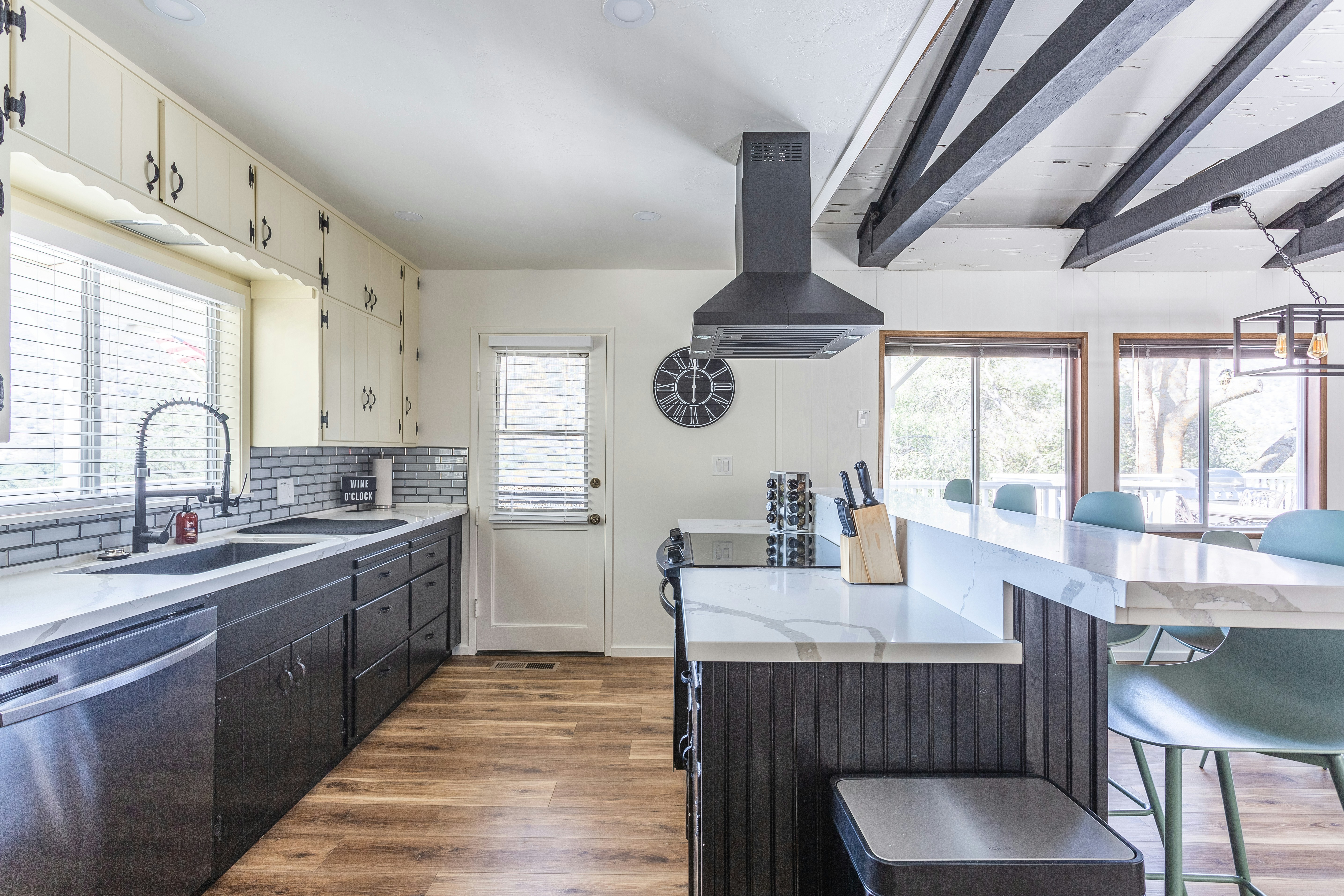Modern kitchen renovation with dark cabinetry, brass fixtures, and marble island in Limpopo home