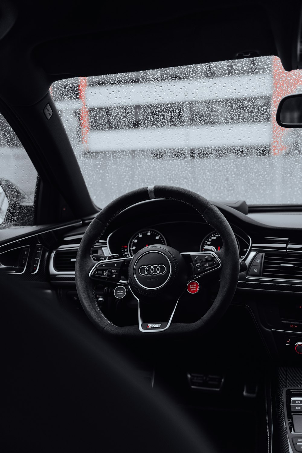 the interior of a car with a steering wheel and dashboard