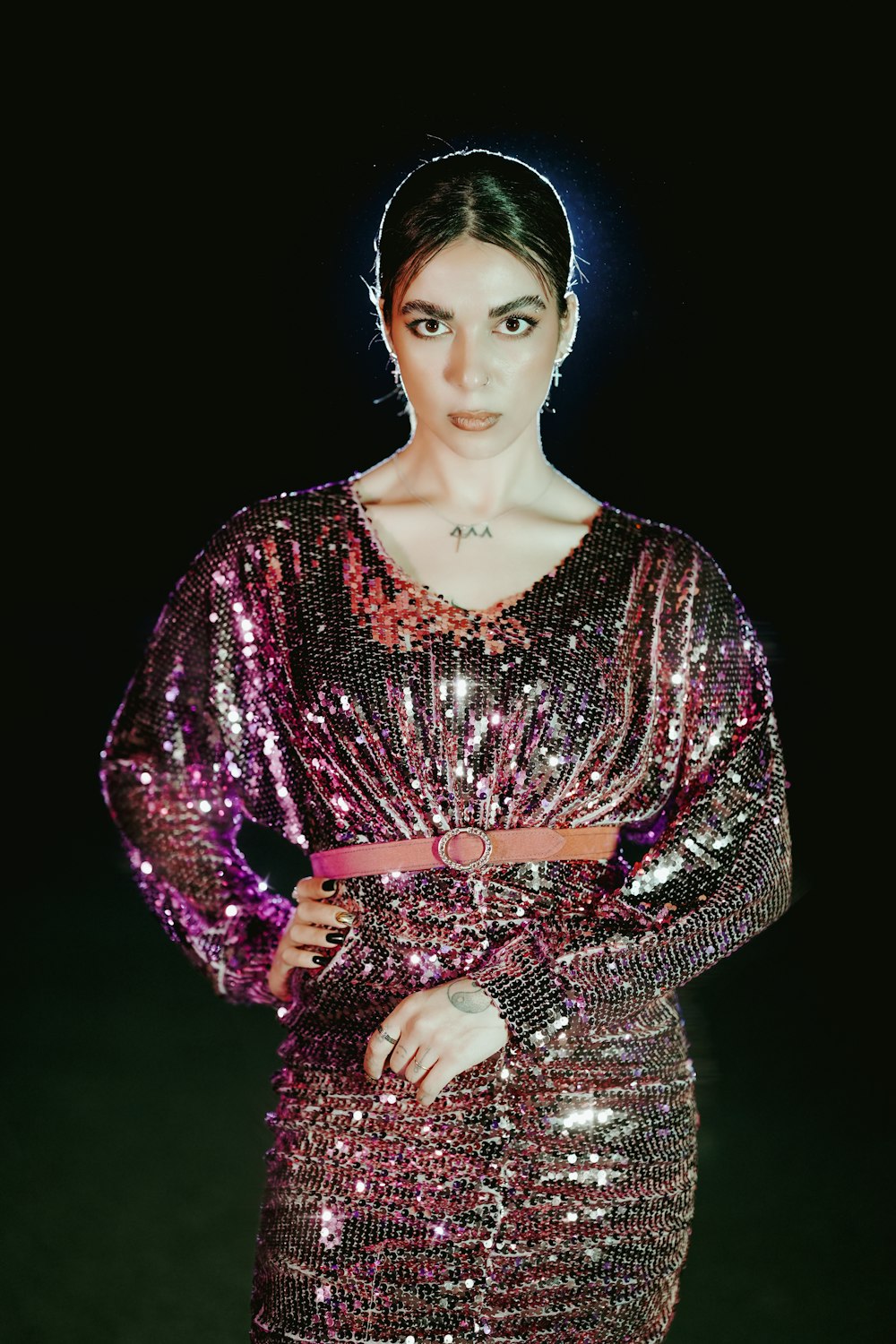 a woman in a sequin dress posing for a picture