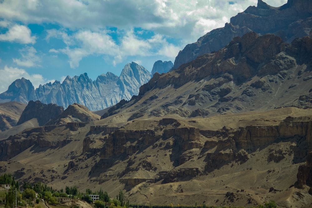 a mountain range with a house in the foreground