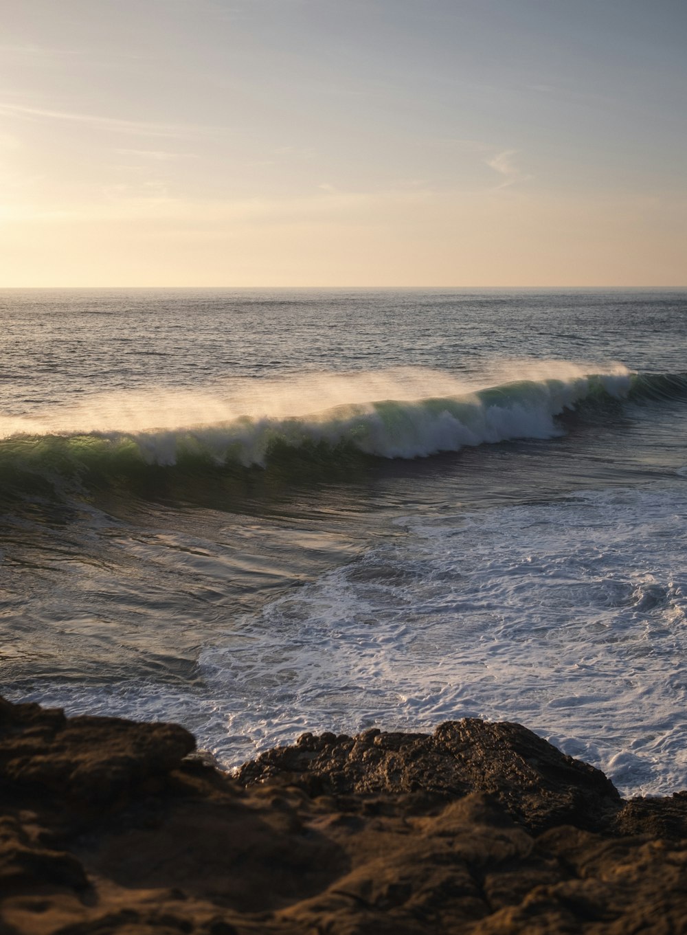 a person riding a surfboard on a wave in the ocean