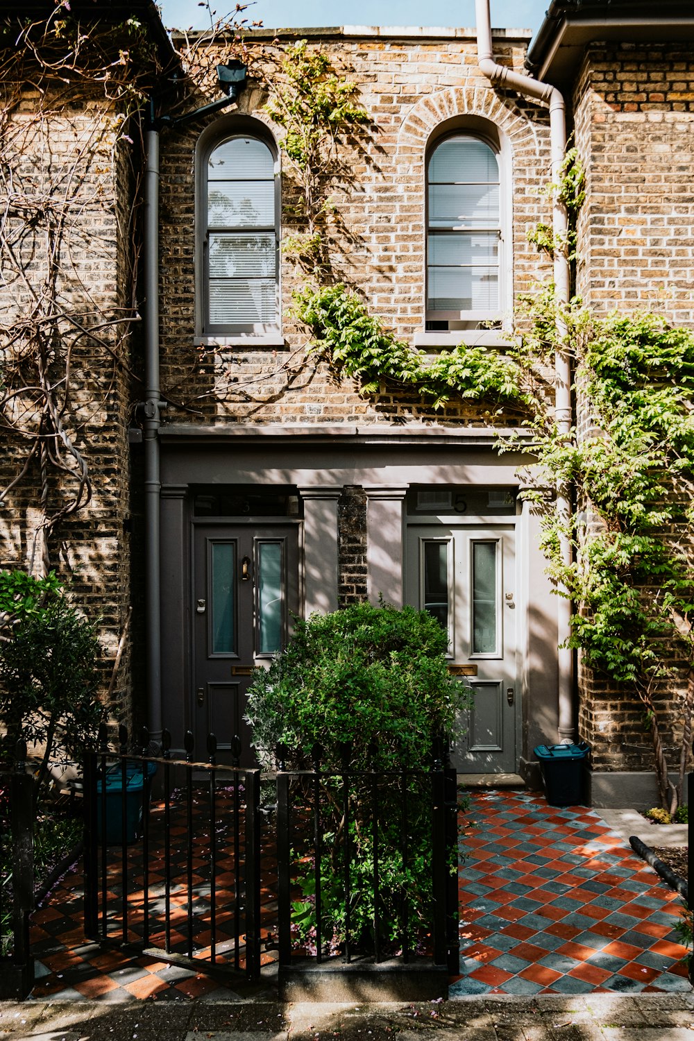 a brick building with two windows and a door