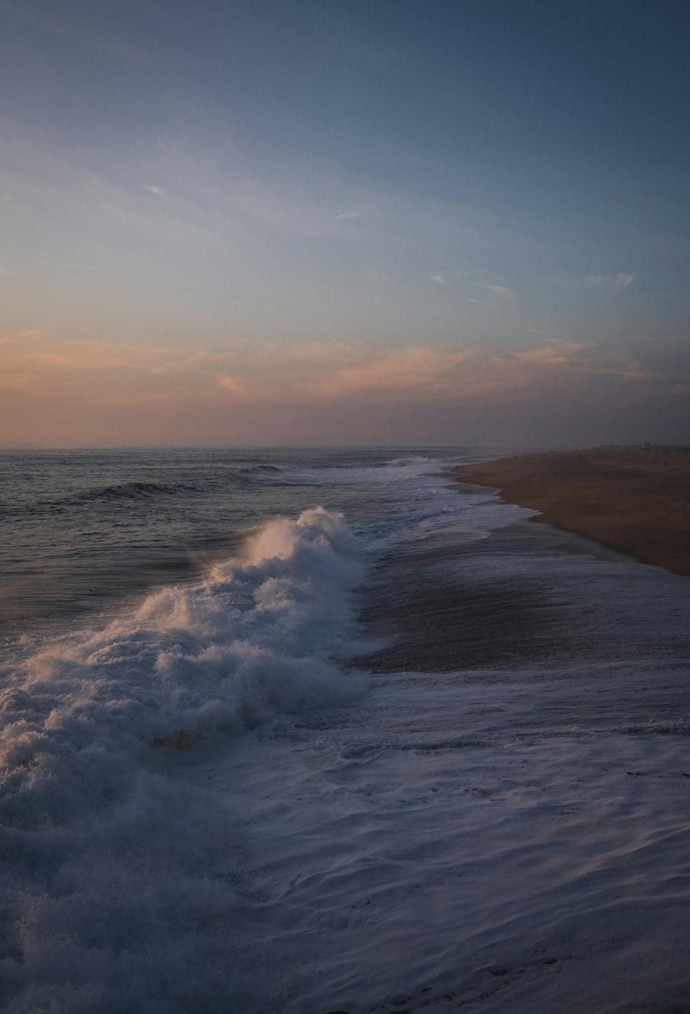 a beach with waves coming in to shore