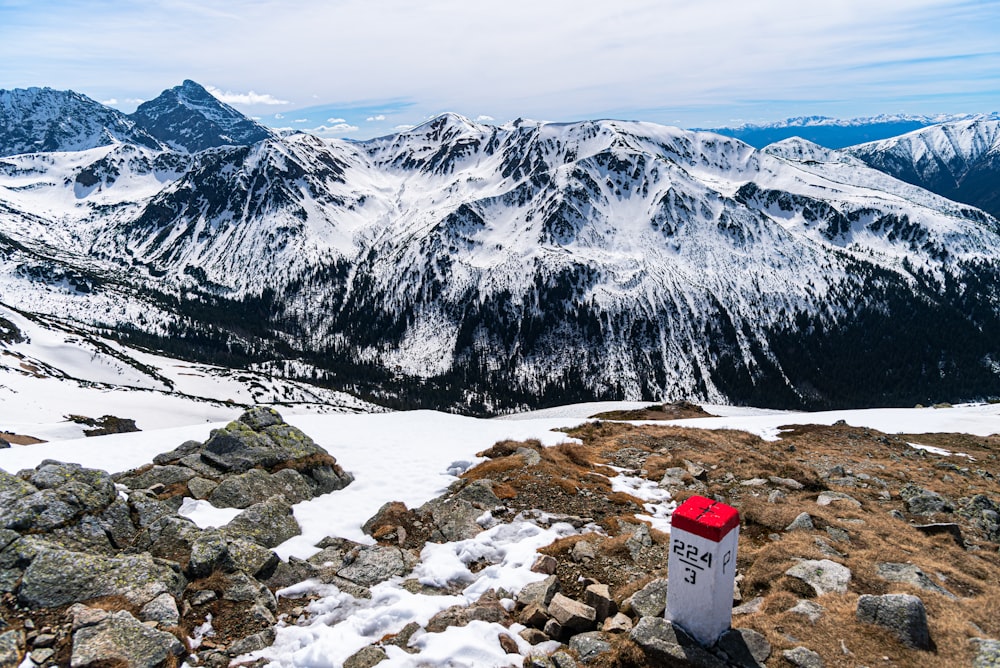 a red box sitting on top of a snow covered mountain