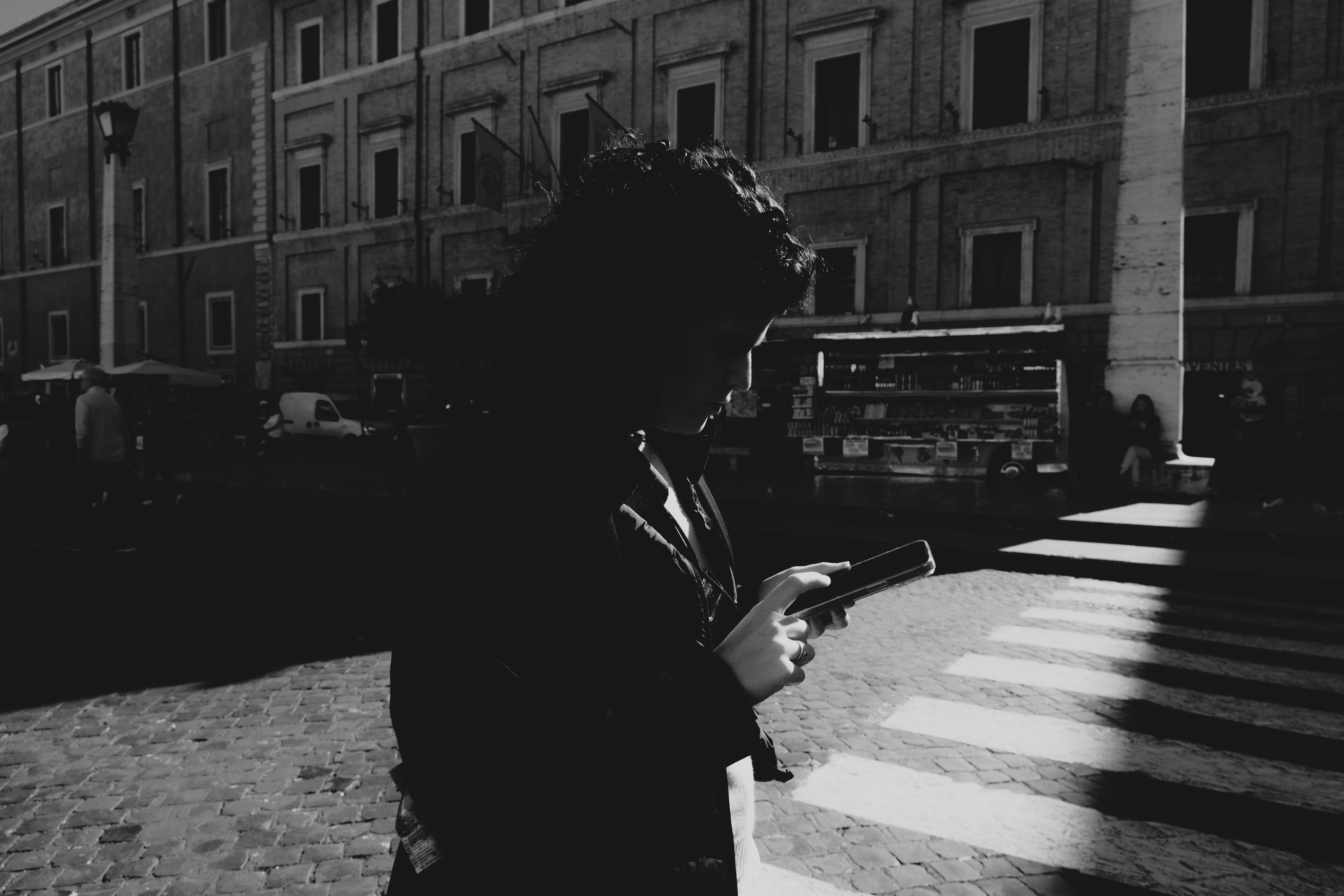 a man in a suit looking at his cell phone