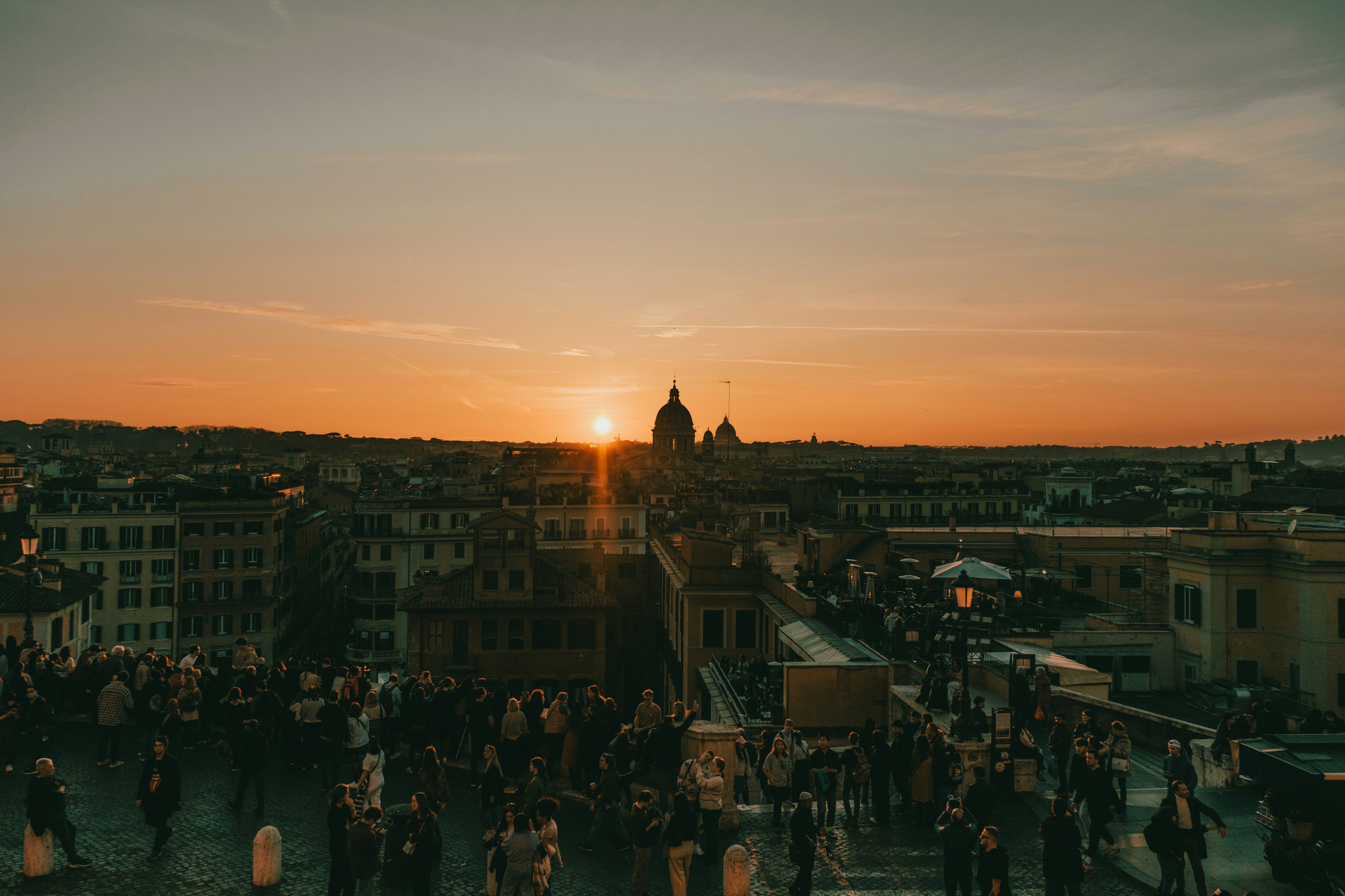 a group of people standing on top of a roof
