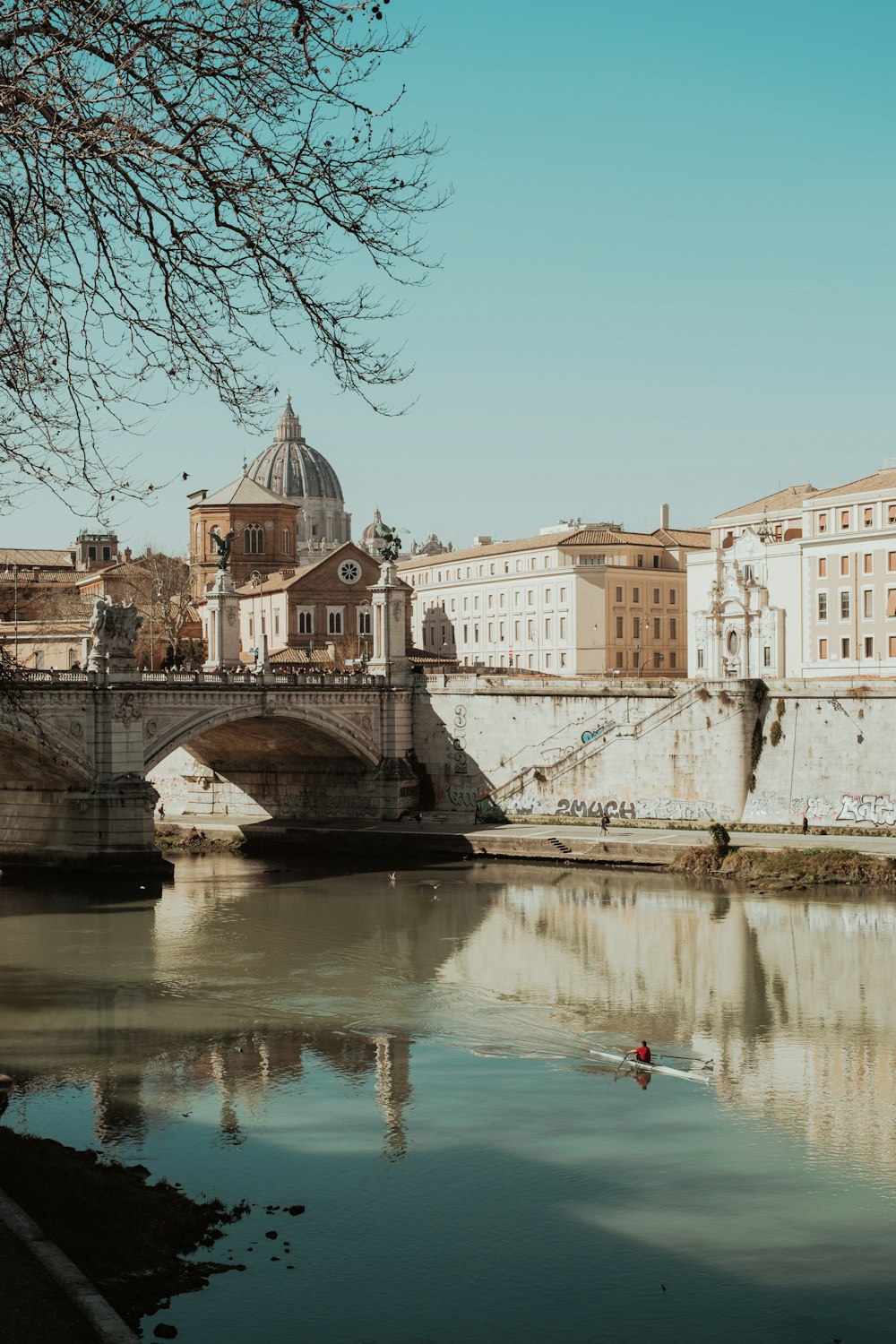 a bridge over a body of water with buildings in the background