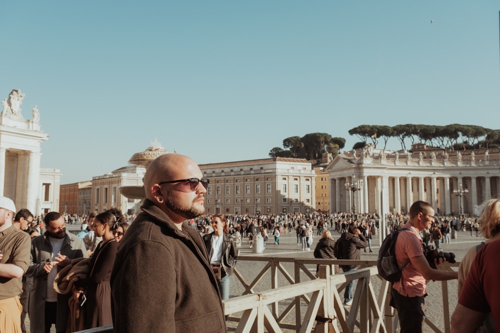 a man standing on a bridge in front of a crowd of people