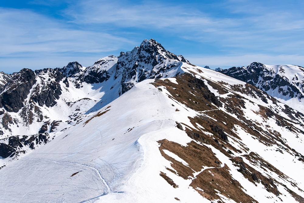 a snow covered mountain with a sky background