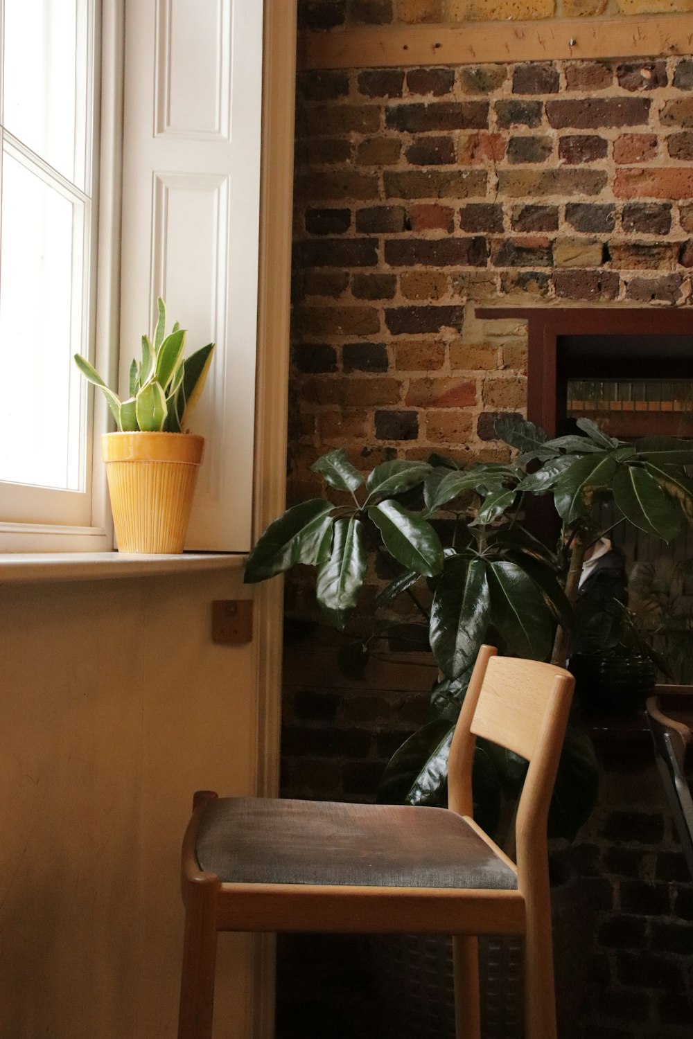 a wooden chair sitting next to a window