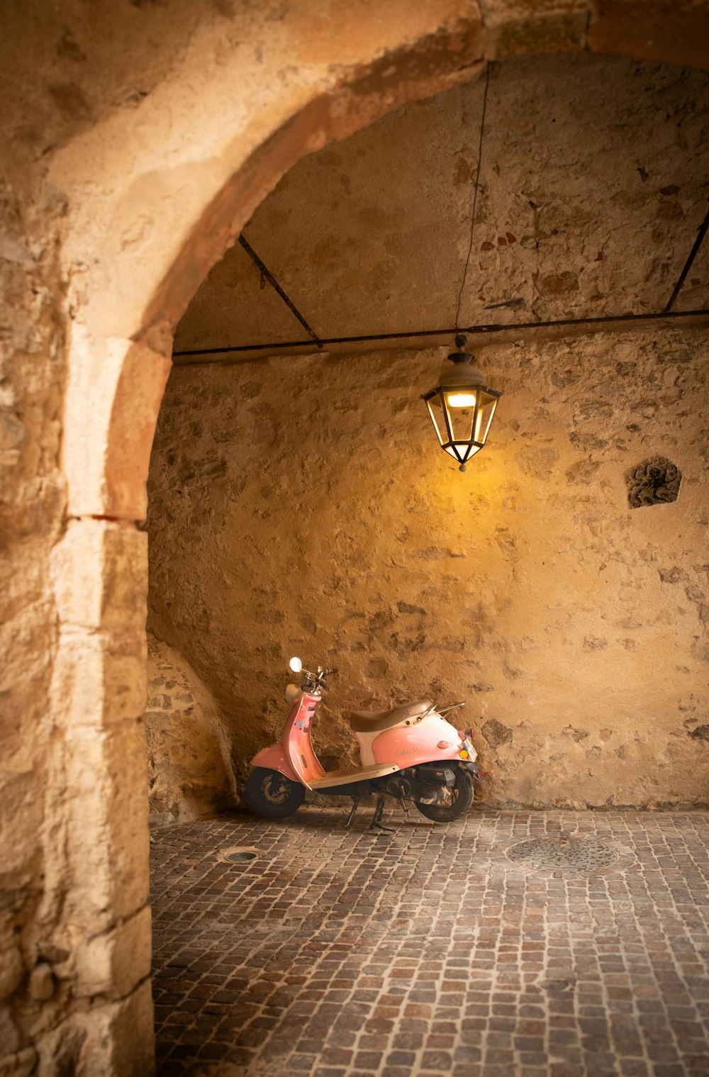 a scooter is parked in a stone tunnel