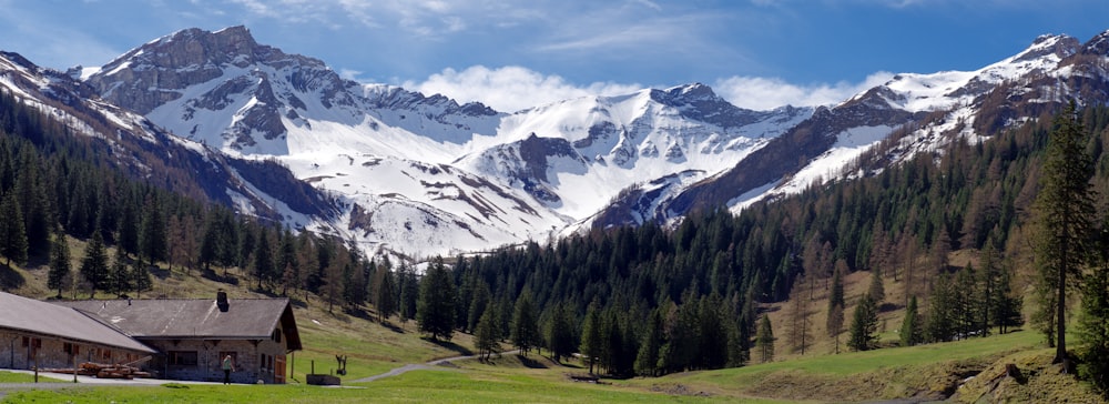 a mountain range with a house in the foreground