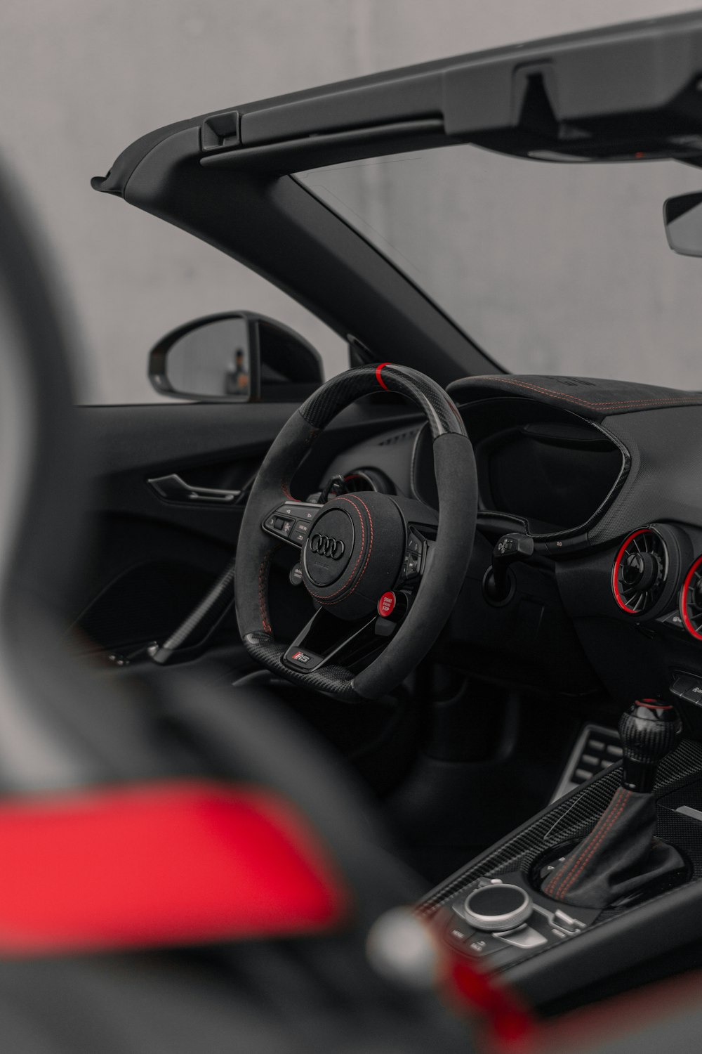 the interior of a sports car with a steering wheel