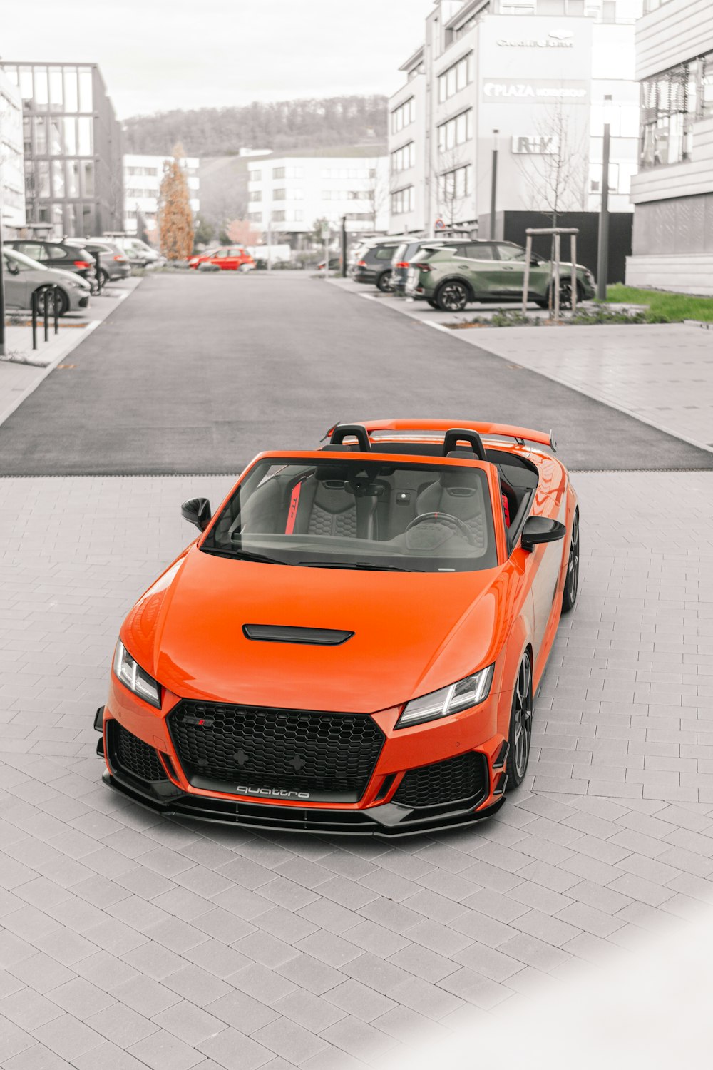 an orange sports car parked in a parking lot