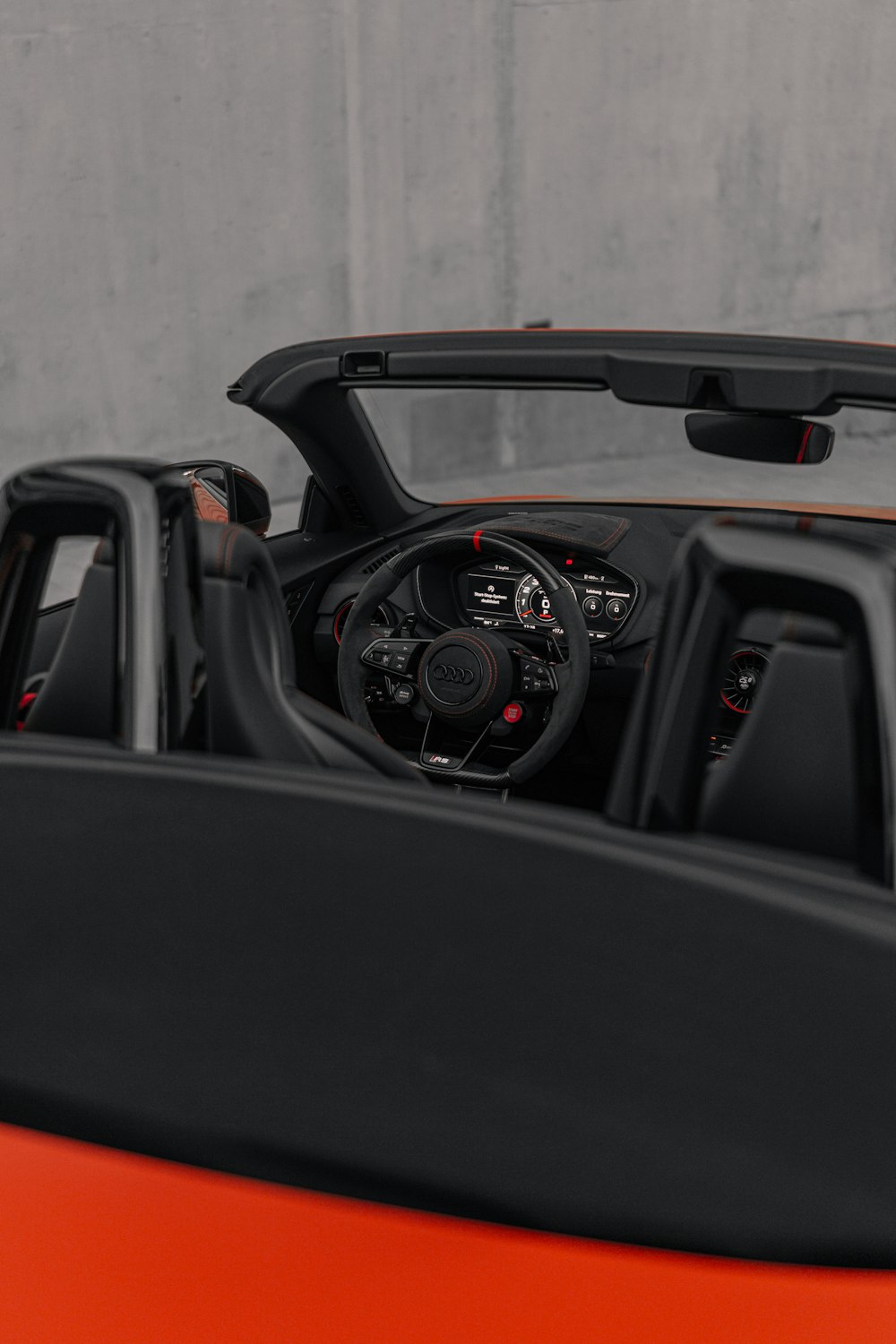 the interior of an orange sports car