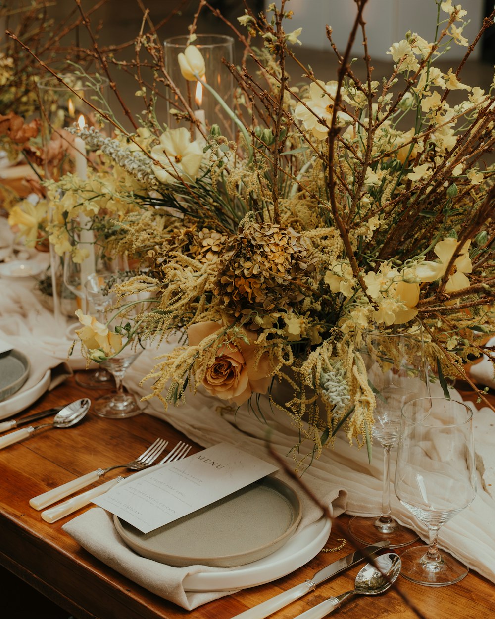 a wooden table topped with a vase filled with flowers