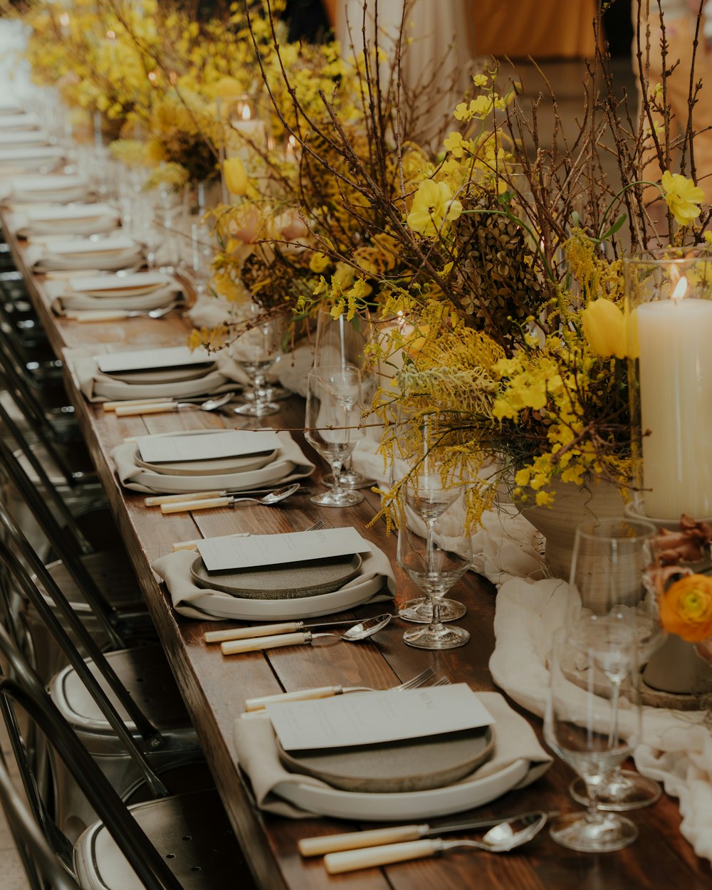 a long table is set with place settings and place settings