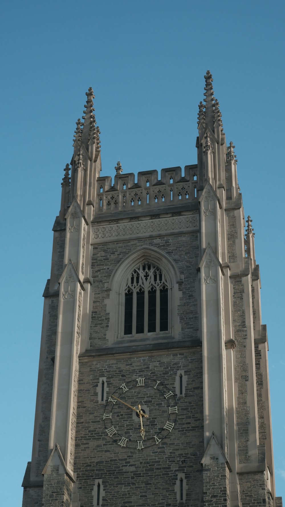 a large clock tower with a sky background