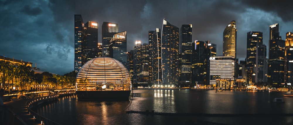 a city skyline at night with lights reflecting in the water