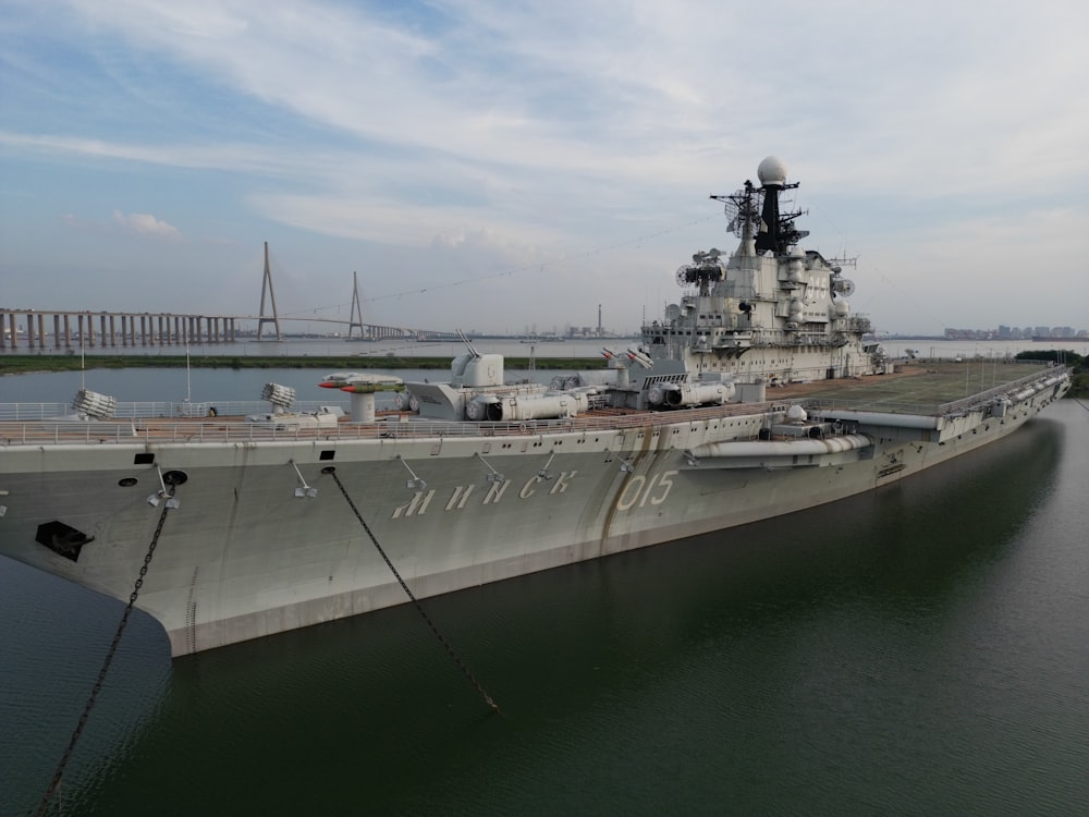 a large military ship docked in the water
