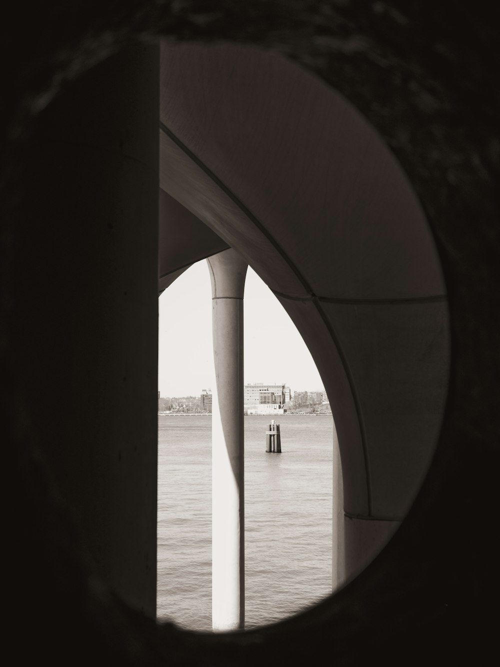 a view of a body of water through a circular window