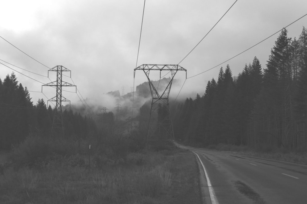 a black and white photo of power lines and trees