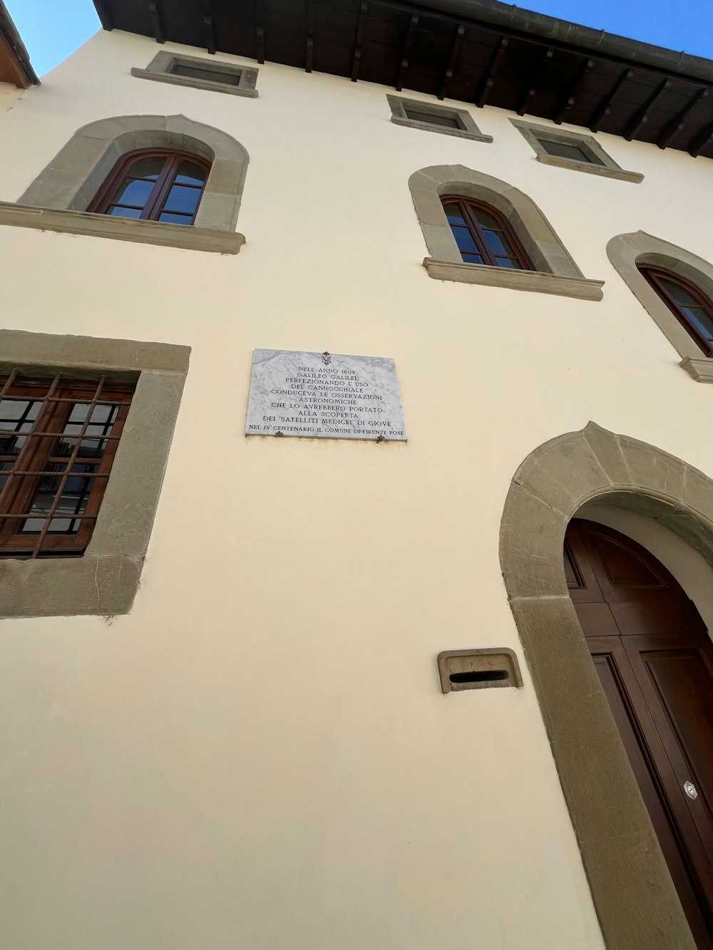 a building with several windows and a sign on the side of it