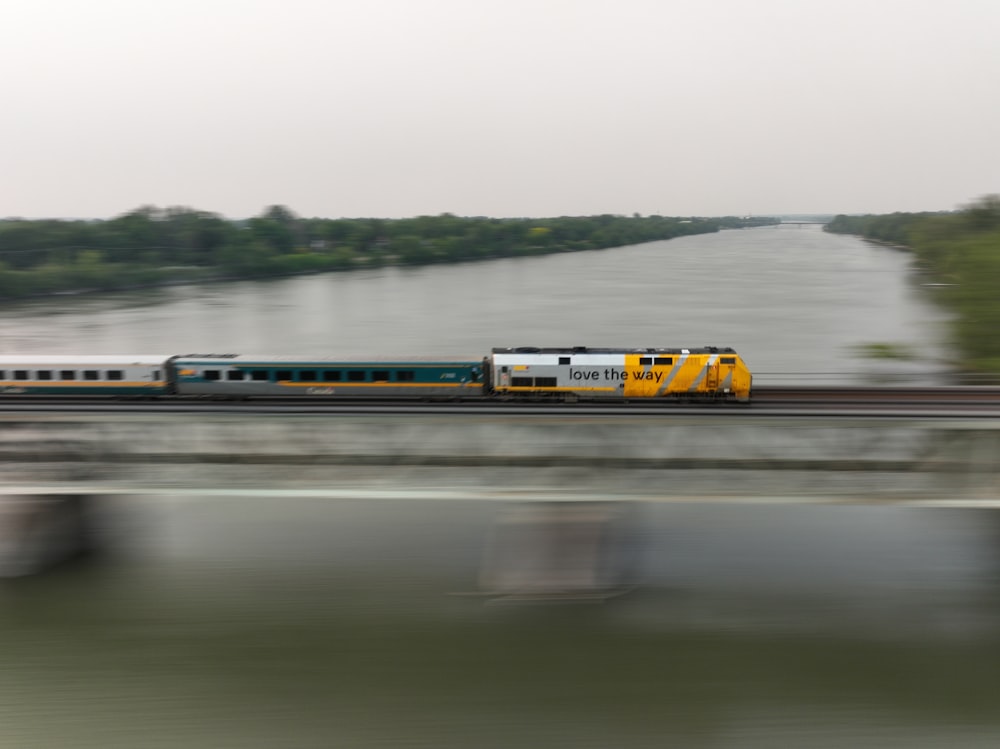 a train traveling over a bridge next to a river