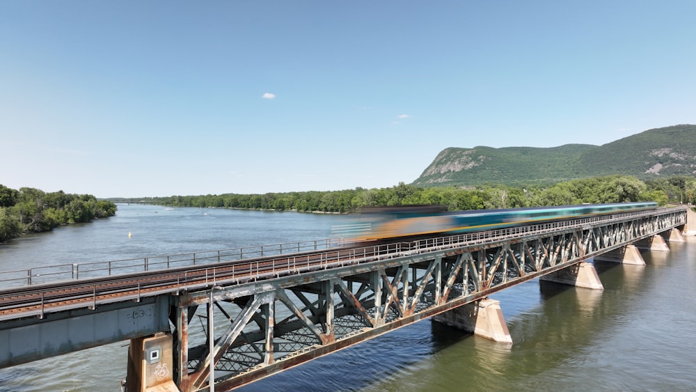 a train traveling over a bridge over a river