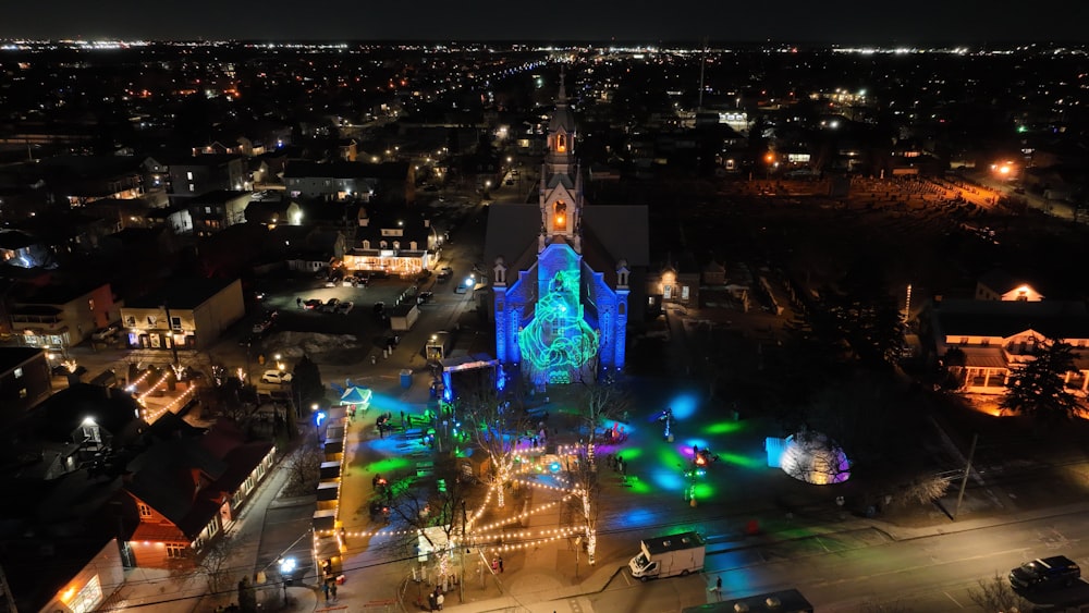an aerial view of a church lit up at night