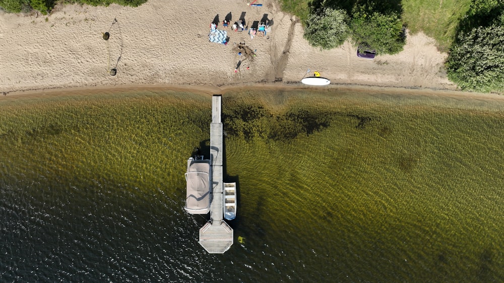 an aerial view of a boat dock on a lake